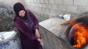 Om Khaled preparing Tannour bread in Kafranbel. Residents of the North are accustomed to bake their own bread due to shortage of bread.